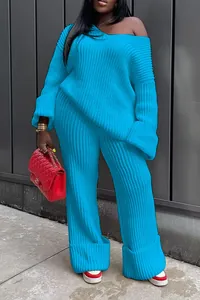 Detail view of women's oversized blue knit sweater and matching wide-leg trousers set