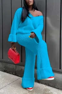 Detail of vibrant blue ribbed knit two-piece set with V-neck sweater and wide-leg pants