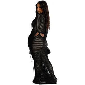 Macro detail showing the intricate black knitted mesh and fringe of the beach dress