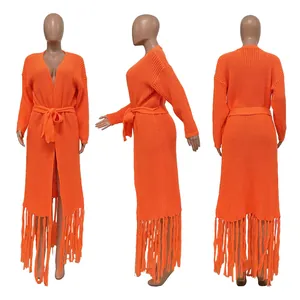 Detailed view of an orange long-knit cardigan featuring stylish fringe hem and a waist tie.