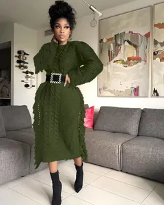 Detailed close-up of olive green cable knit sweater dress with side fringe styling