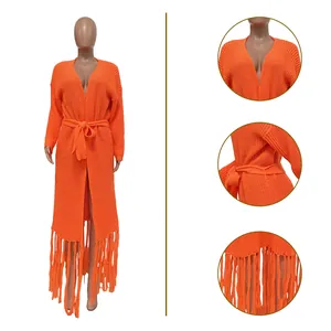 Detail views of orange long knit cardigan sweater featuring fringe hem and belted waist