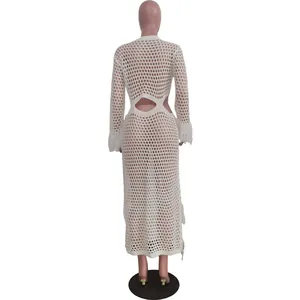 White crochet long sleeve beach dress with tassels and back cutout detail.