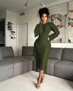 Detailed view of dark green cable knit midi dress with side fringe accents