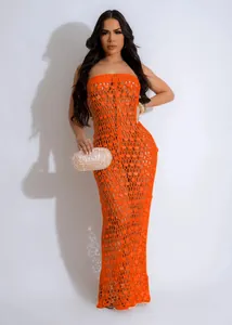 Front view of orange knitted sequined hollow-out beach dress on model in studio