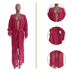 Detailed view of women's fuchsia long knit cardigan with stylish fringes and waist tie