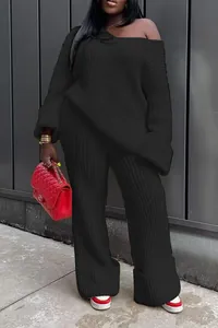 Detail view of women's black ribbed knit two-piece set with off-shoulder sweater