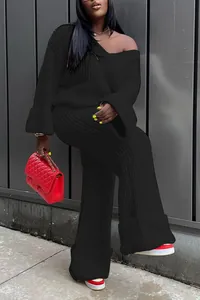 Detail view of black ribbed knit two-piece set with off-shoulder top and wide-leg trousers
