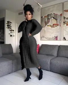 Close-up of elegant long black cable-knit dress with stylish fringe details