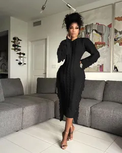 Elegant black cable-knit midi dress with stylish fringe trim details and long sleeves