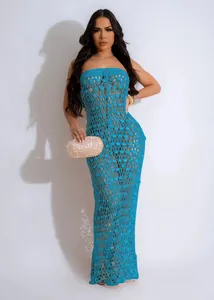 Blue knitted off-the-shoulder sequin hollow-out beach dress worn by a professional model.