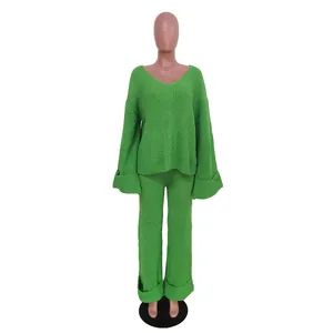 Vibrant green two-piece ribbed knit sweater and pants set shown on a female mannequin