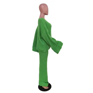 Detailed side view of a women's loose casual solid green knitted two-piece outfit