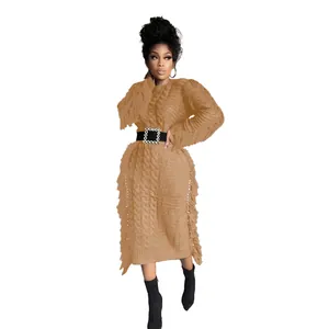 Elegant long sleeve cable-knit sweater dress with tassel fringe detailing and belt.