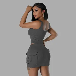 Close-up of a two-piece grey ribbed set featuring a sleeveless top and pocketed mini skirt