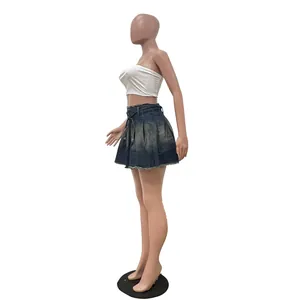 Vista lateral que muestra el ajuste de una minifalda plisada de denim lavado en maniquí