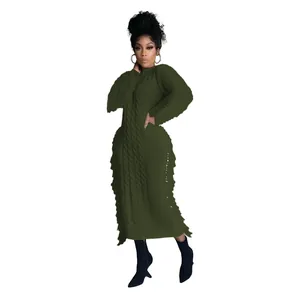 Detailed view of women's long-sleeved dark green cable knit maxi dress with fringe