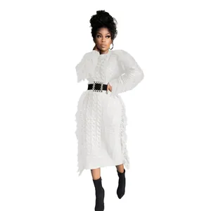 Elegant white long-sleeved cable-knit dress with fringe details and black belt