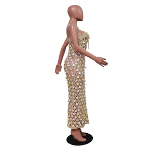 Detailed view of crochet strapless beach dress with shimmering sequins and hollow design.