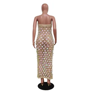 Back view of a beige knitted hollow out beach dress with holographic sequins decoration