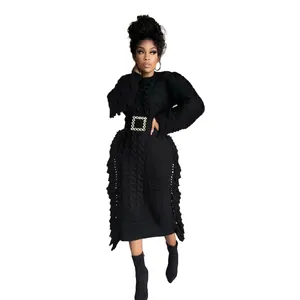 Detail of black cable knit sweater dress with side fringe and rhinestone buckle belt