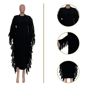 Detailed views of black cable knit sweater dress featuring heavy side fringe and tassels