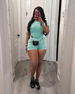 Model wearing turquoise ribbed two-piece outfit with cutout detail in mirror selfie
