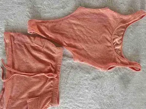 Detailed view of women's orange jacquard bikini and matching skirt two-piece set.