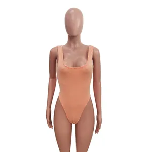 Close-up detail of an orange textured jacquard one-piece bodysuit with thick shoulder straps