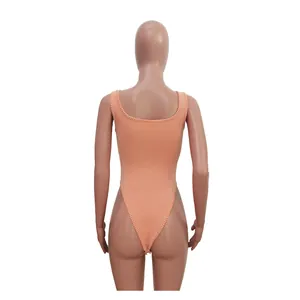 Detailed back view of a peach jacquard ribbed one-piece bodysuit on a display mannequin