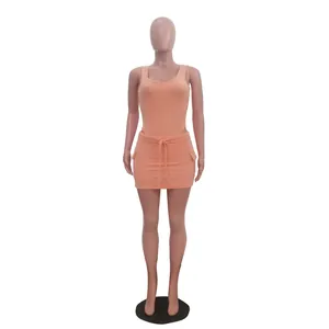 Peach ribbed knit two-piece set including a bodysuit and matching mini skirt on mannequin