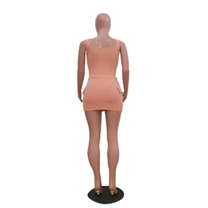 Back view of peach ribbed two-piece set with tank top and pocketed mini skirt