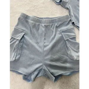 Detailed view of women's light blue ribbed cargo shorts featuring side pockets