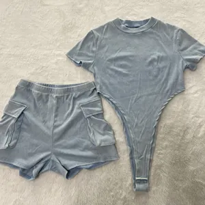 Detailed flat lay of washed blue ribbed short sleeve bodysuit and cargo shorts set