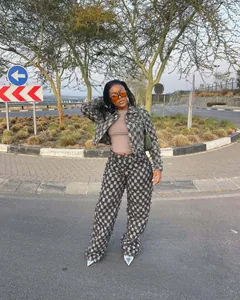 Model wearing a trendy gray checkerboard jacquard denim jacket and matching wide-leg pants.
