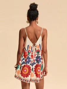 Detailed back view of a summer floral print cami romper with stylish lace-up back design.