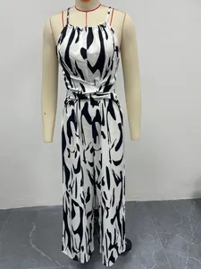 Detailed view of women's black and white milk print halter jumpsuit on mannequin