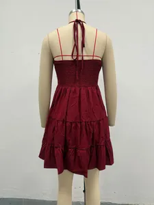 Detailed back view of a burgundy tiered ruffle dress featuring a smocked bodice and halter ties