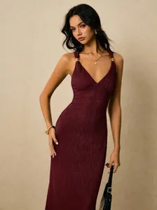 Elegant burgundy pleated bodycon midi dress featuring gold strap hardware accents.