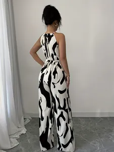 Back view of a chic black and white cow print halter neck wide-leg jumpsuit for women