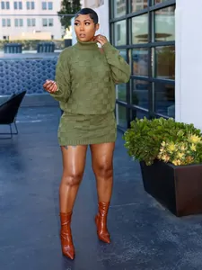 Close-up view of olive green checkerboard knit sweater and skirt set on a model