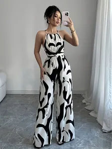 Full-body shot of woman wearing black and white milk print halter wide-leg jumpsuit
