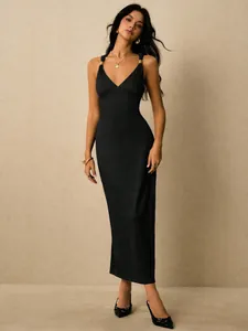 Elegant black ribbed midi dress featuring gold hardware strap details and a slim fit