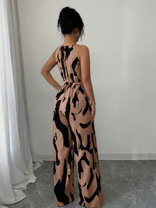 Back view of a halter-neck wide-leg jumpsuit with brown and black abstract print