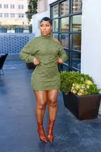 Full view of woman wearing olive green casual checkerboard knit sweater and skirt set