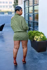 Detail view of the back showing olive green checkered knit sweater and mini skirt set