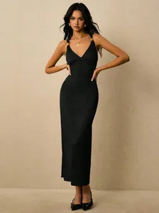 Elegant black ribbed maxi dress with v-neck and gold strap details