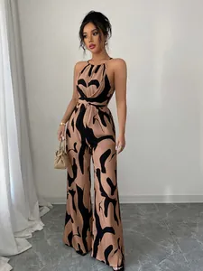 Detail showing a stylish halter neck wide-leg jumpsuit with black abstract print
