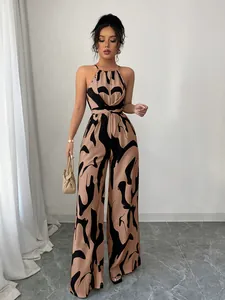 Elegant halter-neck wide-leg jumpsuit with a bold brown and black swirl print design.