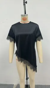 Close-up detail of a black satin T-shirt featuring French lace and asymmetric hemline